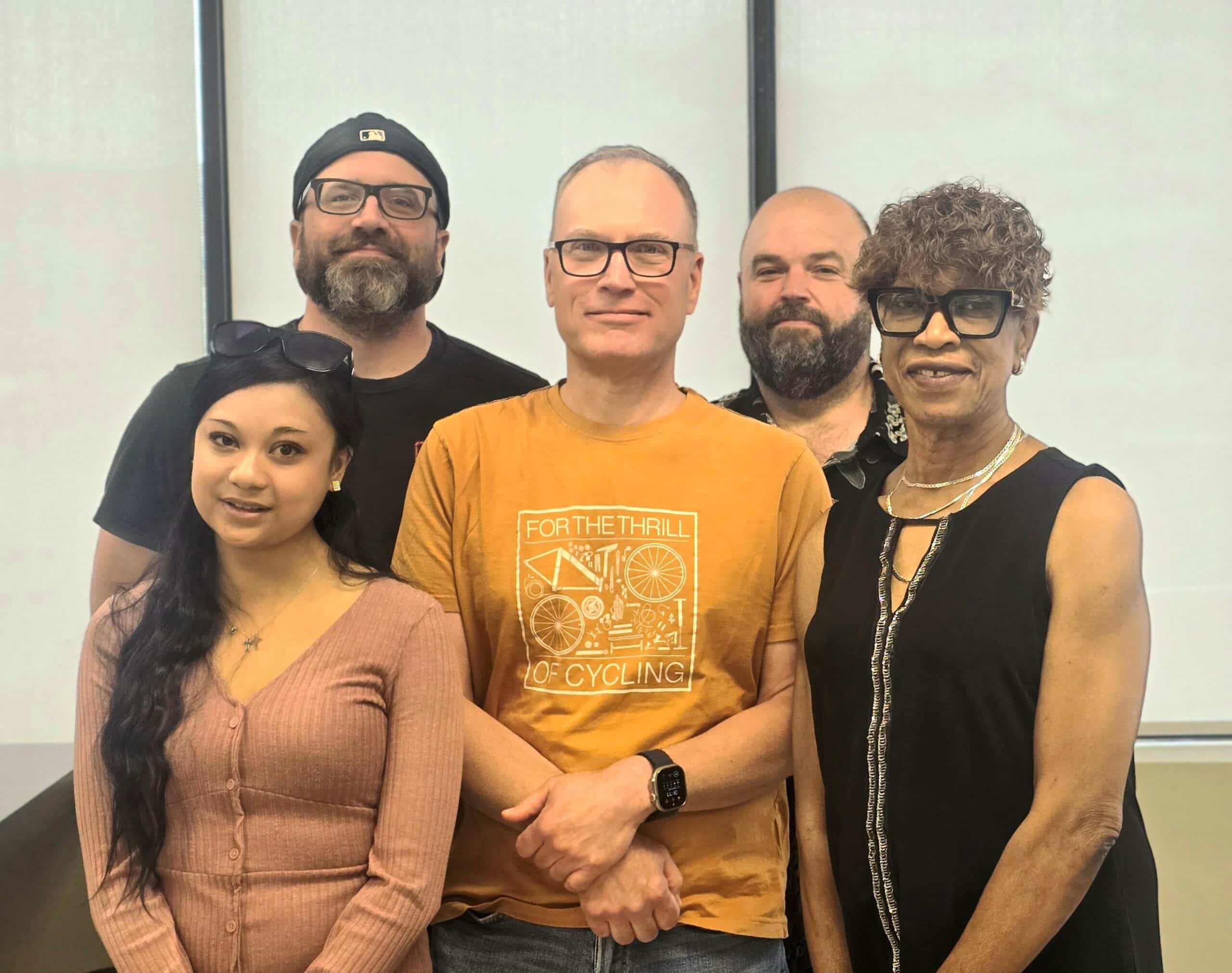 Five bargaining team members standing together in a group